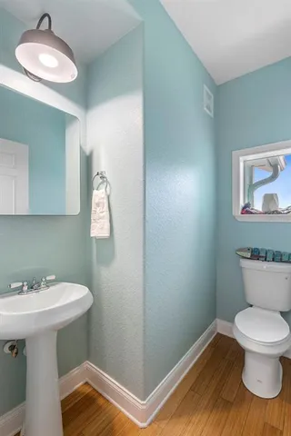 a bathroom with a sink mirror and toilet