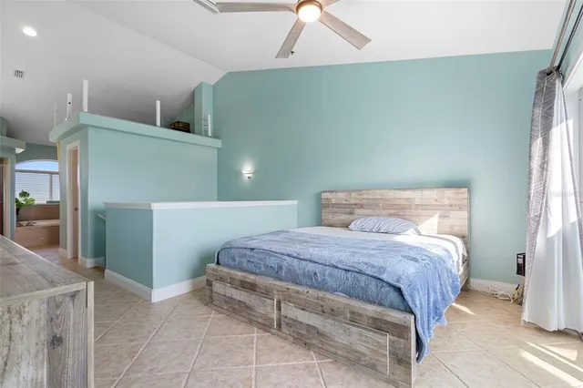 a bedroom with a bed and a mirror