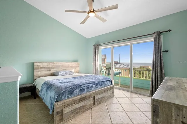 a bedroom with a bed and glass door
