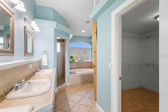 a bathroom with a granite countertop sink a mirror and a bathtub