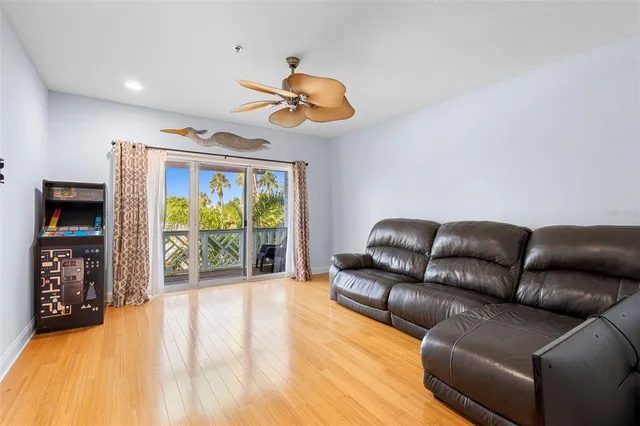 a living room with furniture a flat screen tv and a large window