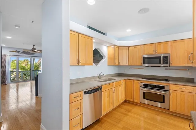 a kitchen with stainless steel appliances granite countertop a stove a sink and a microwave