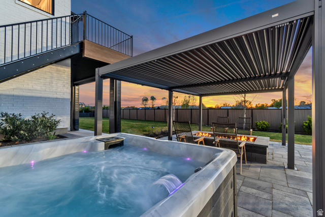 1720 Hillcrest Circle Mapleton, UT 84664 - Photo 20 of 116 Patio terrace at dusk featuring a patio, a fire pit, a hot tub, and a pergola