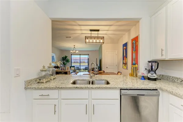a kitchen with sink and mirror