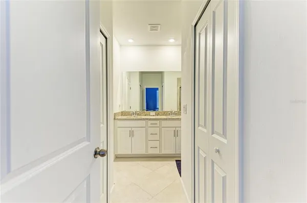 a bathroom with a granite countertop sink a mirror and a shower