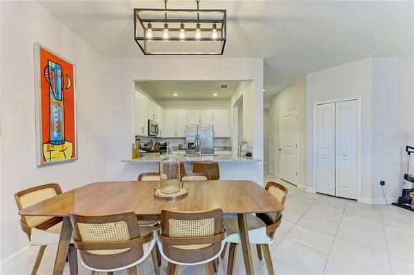 a view of a dining room with furniture and chandelier