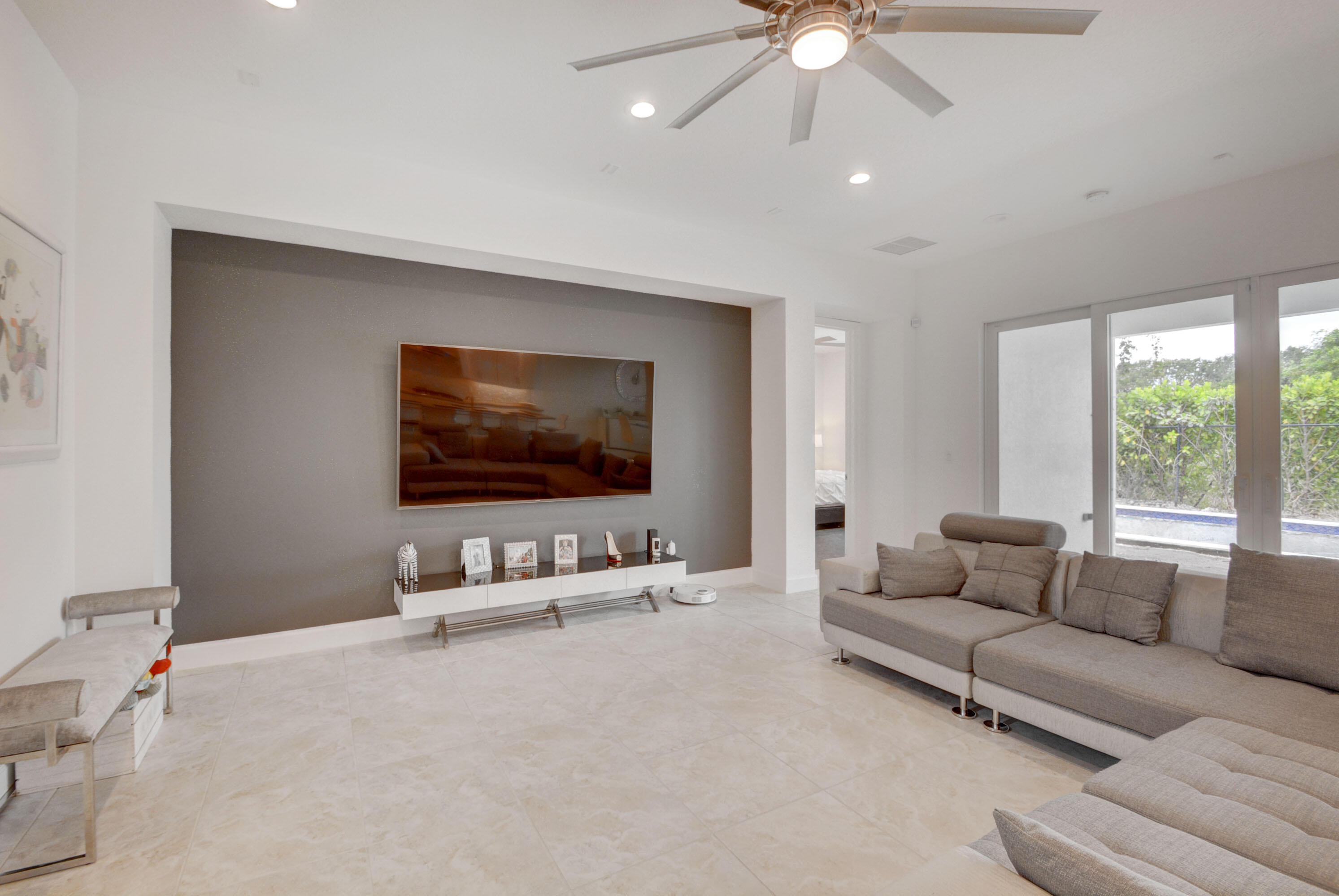 5251 Beland Drive Lake Worth, FL 33467 - Photo 11 of 56 a living room with furniture and a flat screen tv