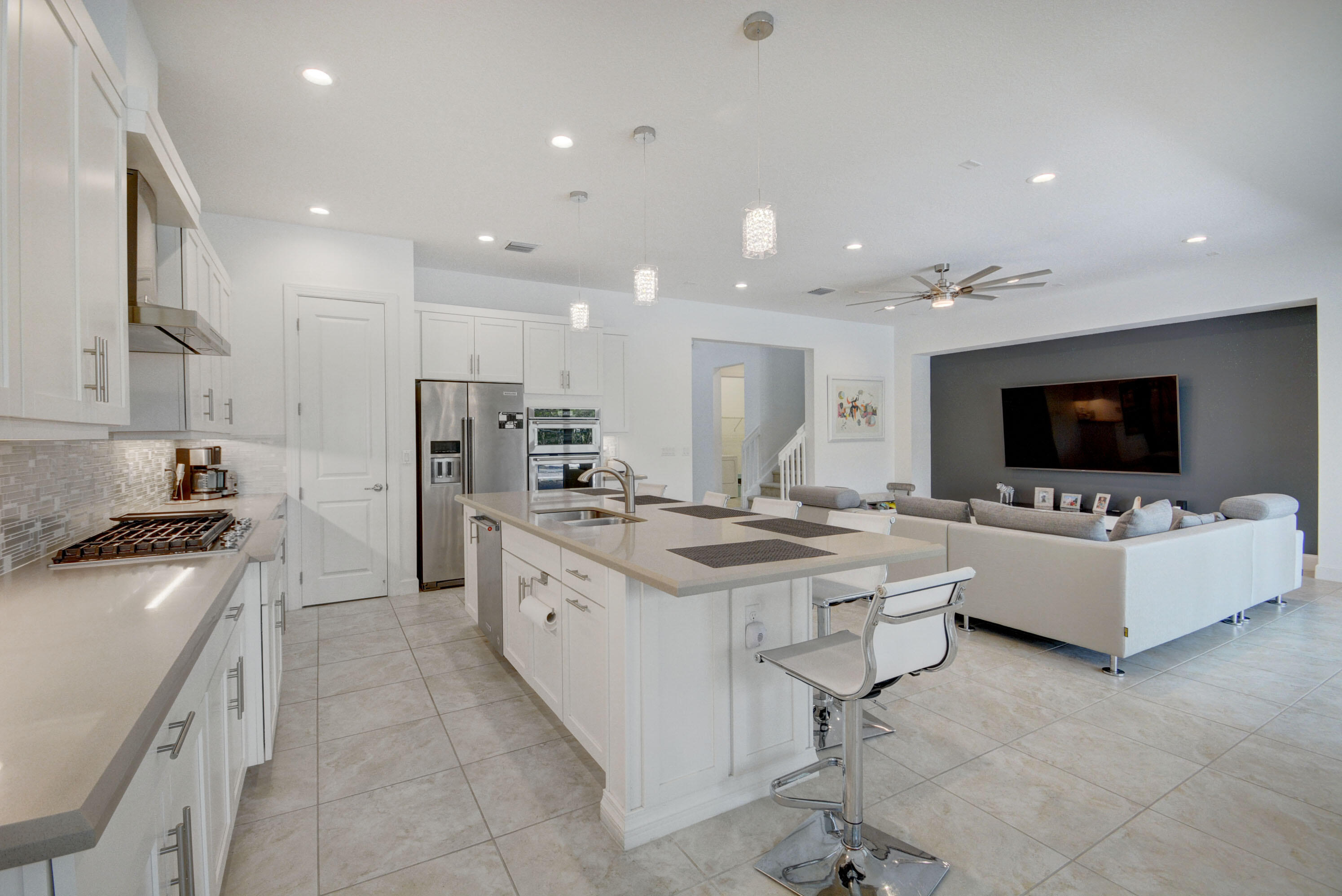 5251 Beland Drive Lake Worth, FL 33467 - Photo 13 of 56 a living room with stainless steel appliances furniture a flat screen tv and kitchen view