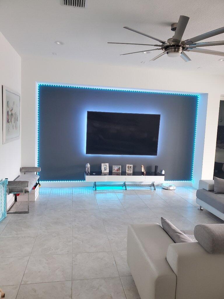 5251 Beland Drive Lake Worth, FL 33467 - Photo 16 of 56 a living room with furniture and a flat screen tv