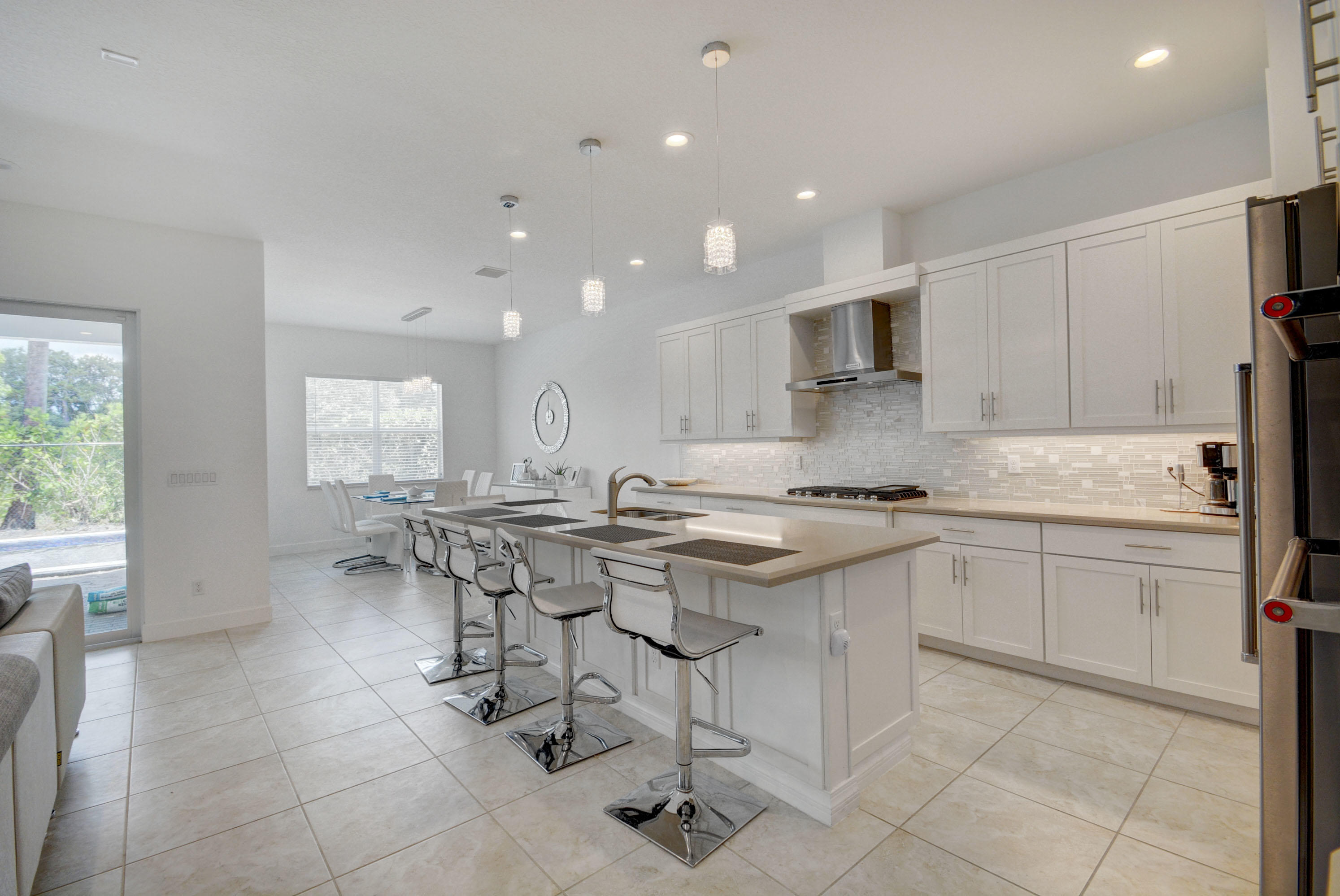 5251 Beland Drive Lake Worth, FL 33467 - Photo 19 of 56 a kitchen with a sink and chairs
