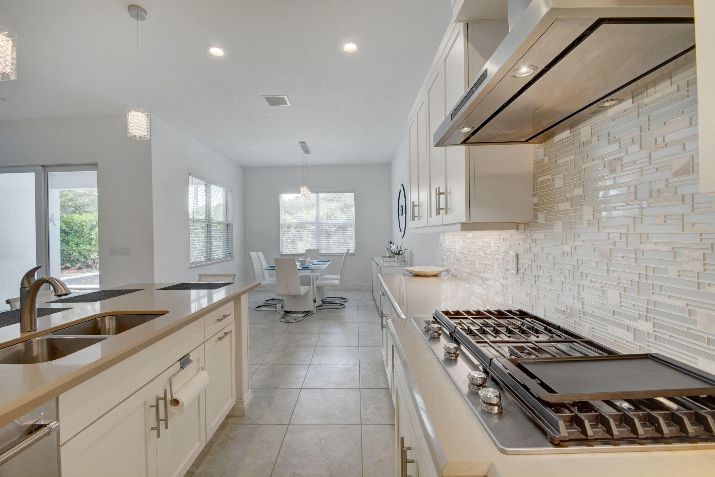 5251 Beland Drive Lake Worth, FL 33467 - Photo 21 of 56 a kitchen with sink stove and cabinets