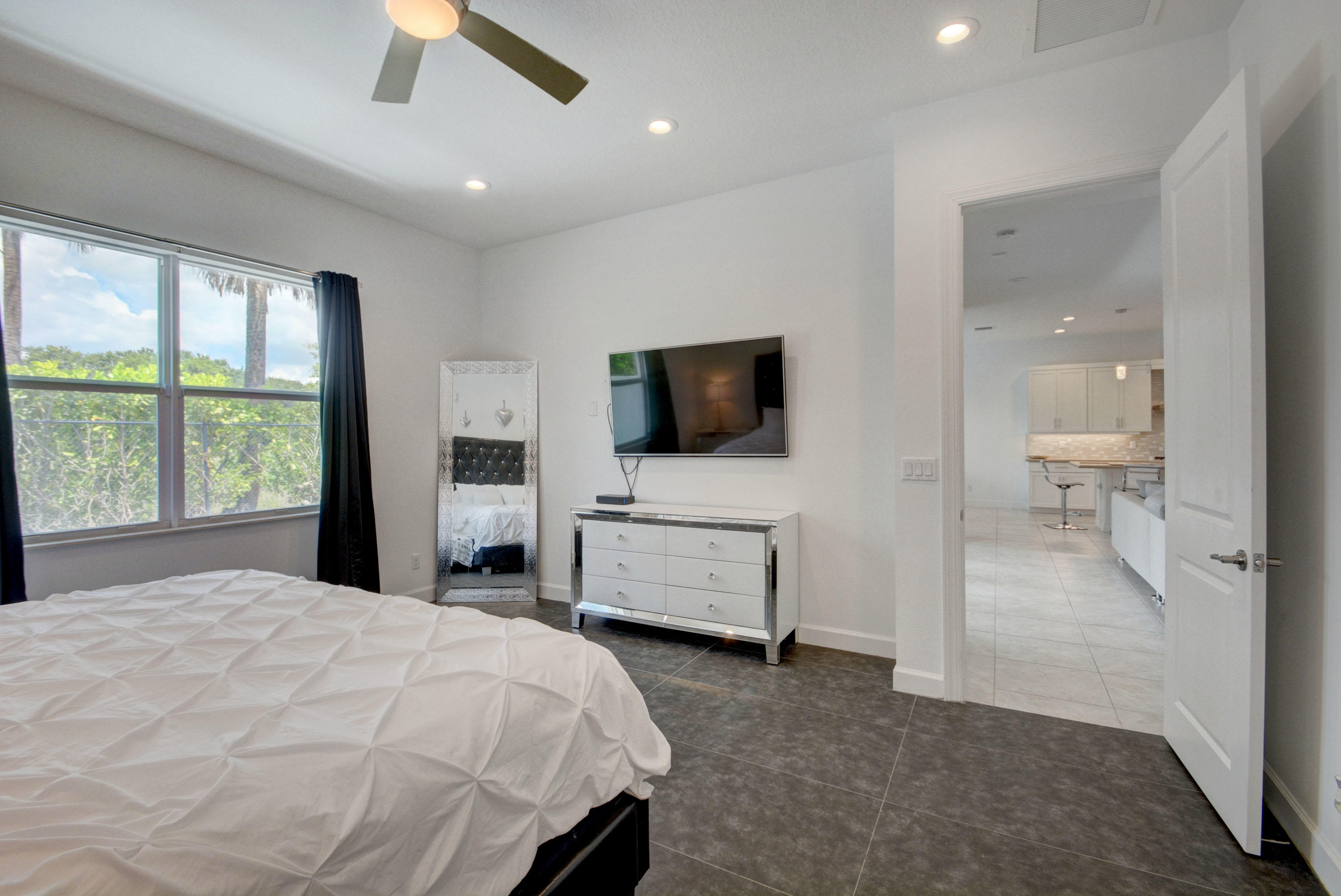 5251 Beland Drive Lake Worth, FL 33467 - Photo 28 of 56 a bedroom with a bed and a flat screen tv