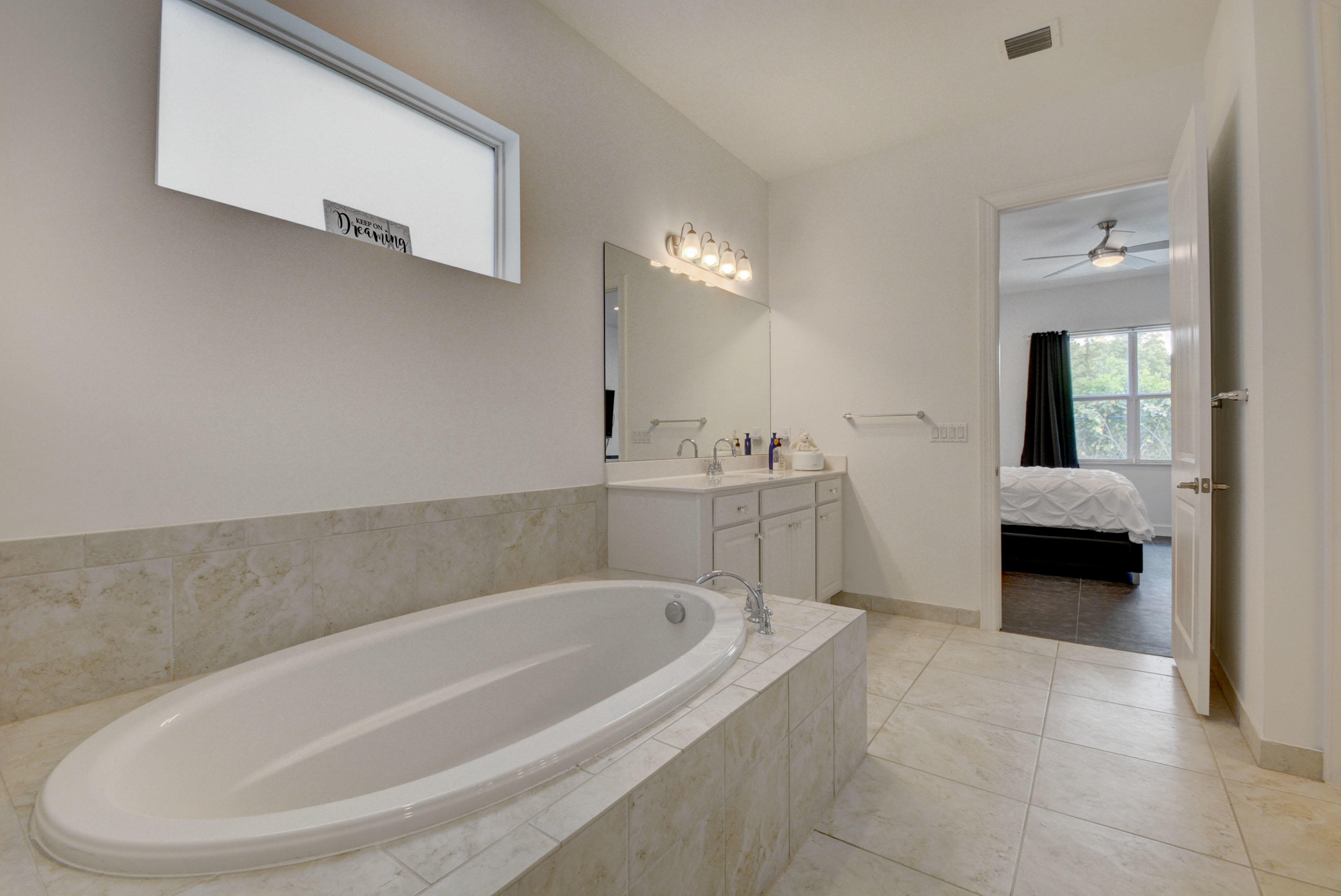 5251 Beland Drive Lake Worth, FL 33467 - Photo 32 of 56 a spacious bathroom with a bathtub and a sink