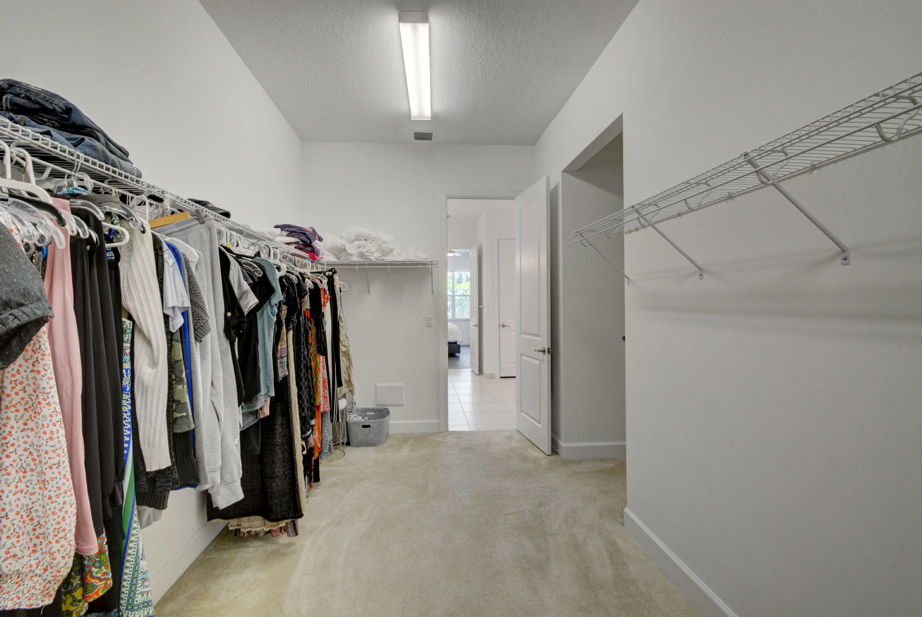 5251 Beland Drive Lake Worth, FL 33467 - Photo 34 of 56 a view of walk in closet with clothes