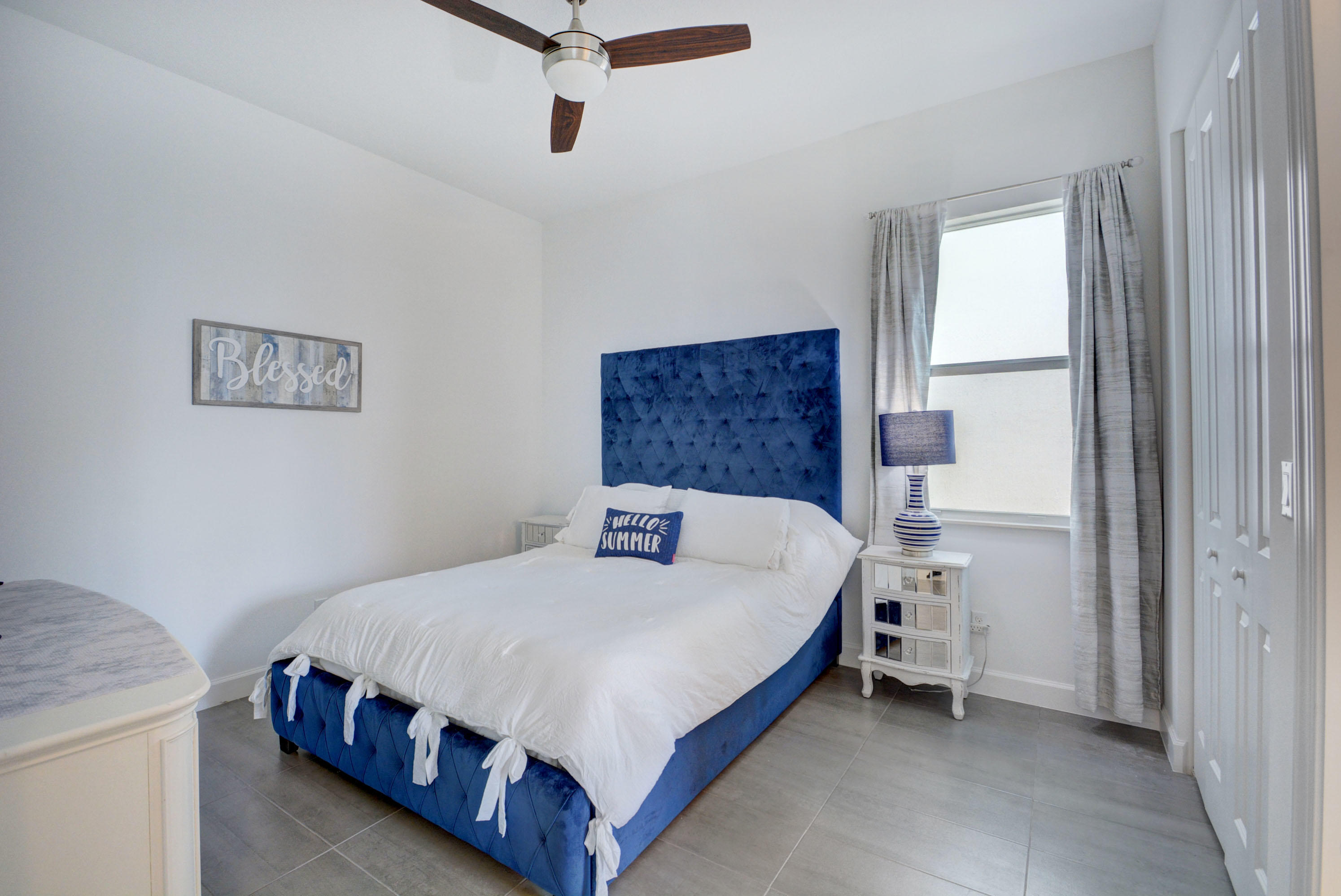 5251 Beland Drive Lake Worth, FL 33467 - Photo 35 of 56 a bedroom with a bed and a window