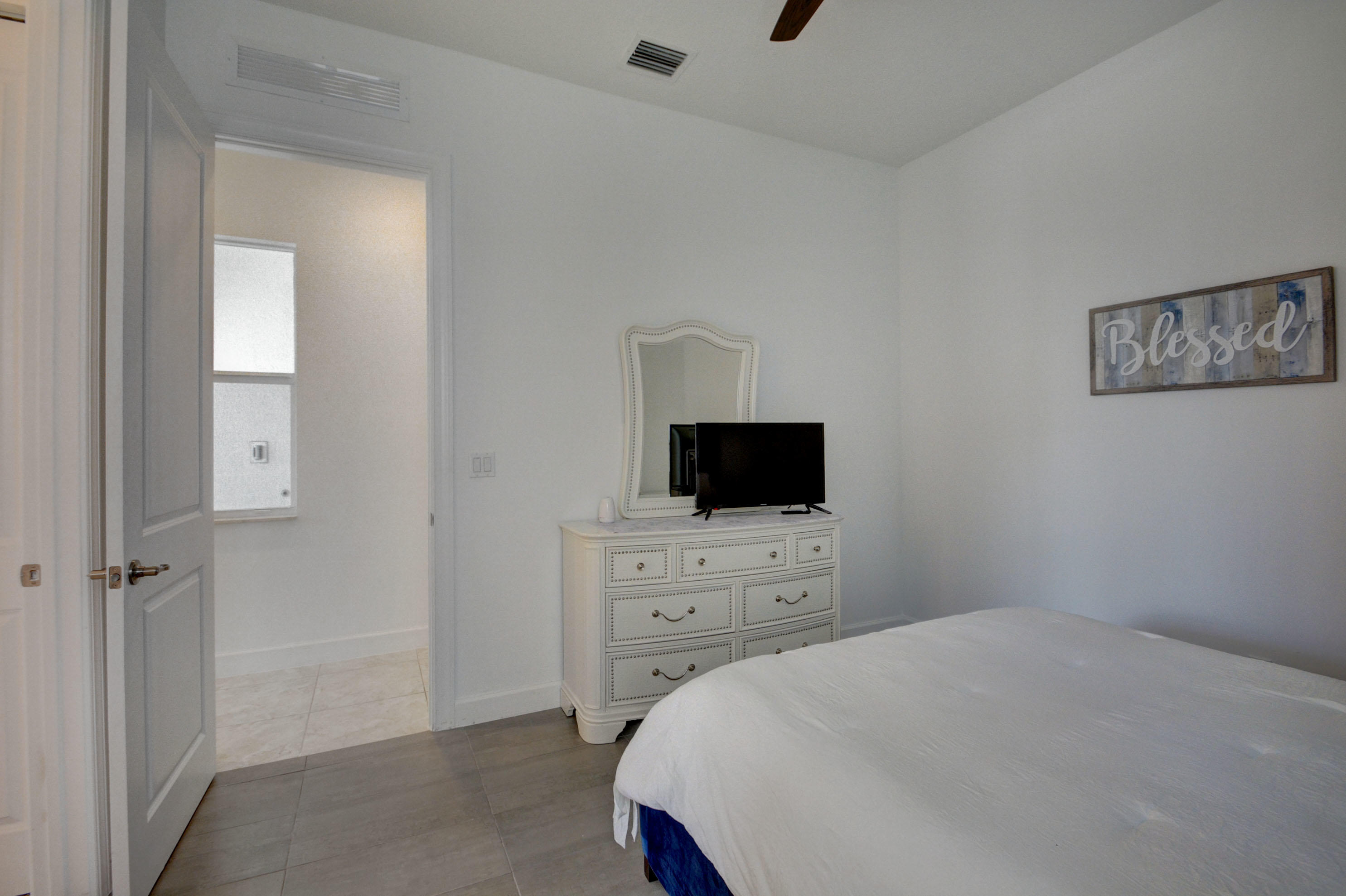 5251 Beland Drive Lake Worth, FL 33467 - Photo 37 of 56 a bedroom with a bed and a flat screen tv