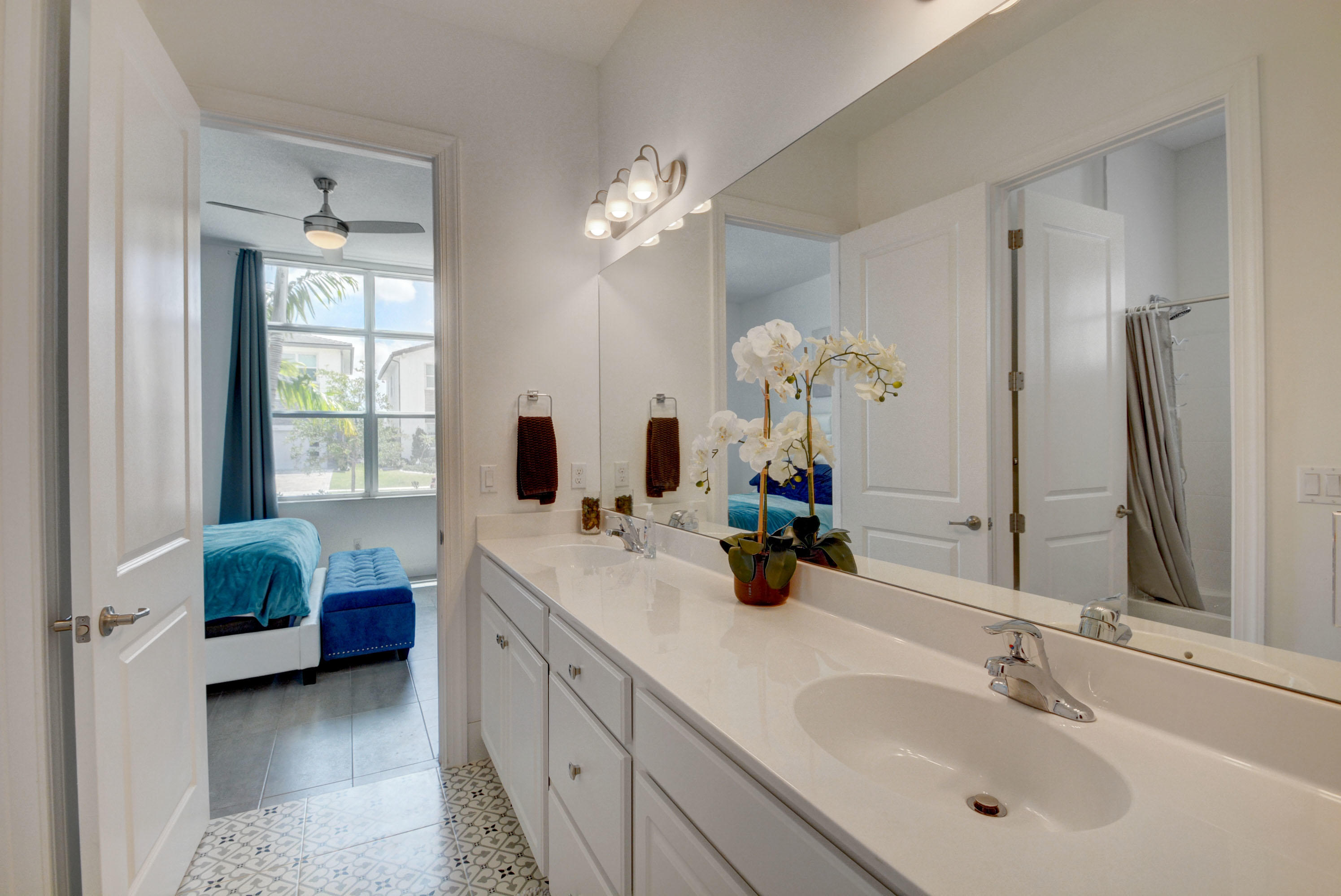 5251 Beland Drive Lake Worth, FL 33467 - Photo 38 of 56 a bathroom with a double vanity sink and a mirror