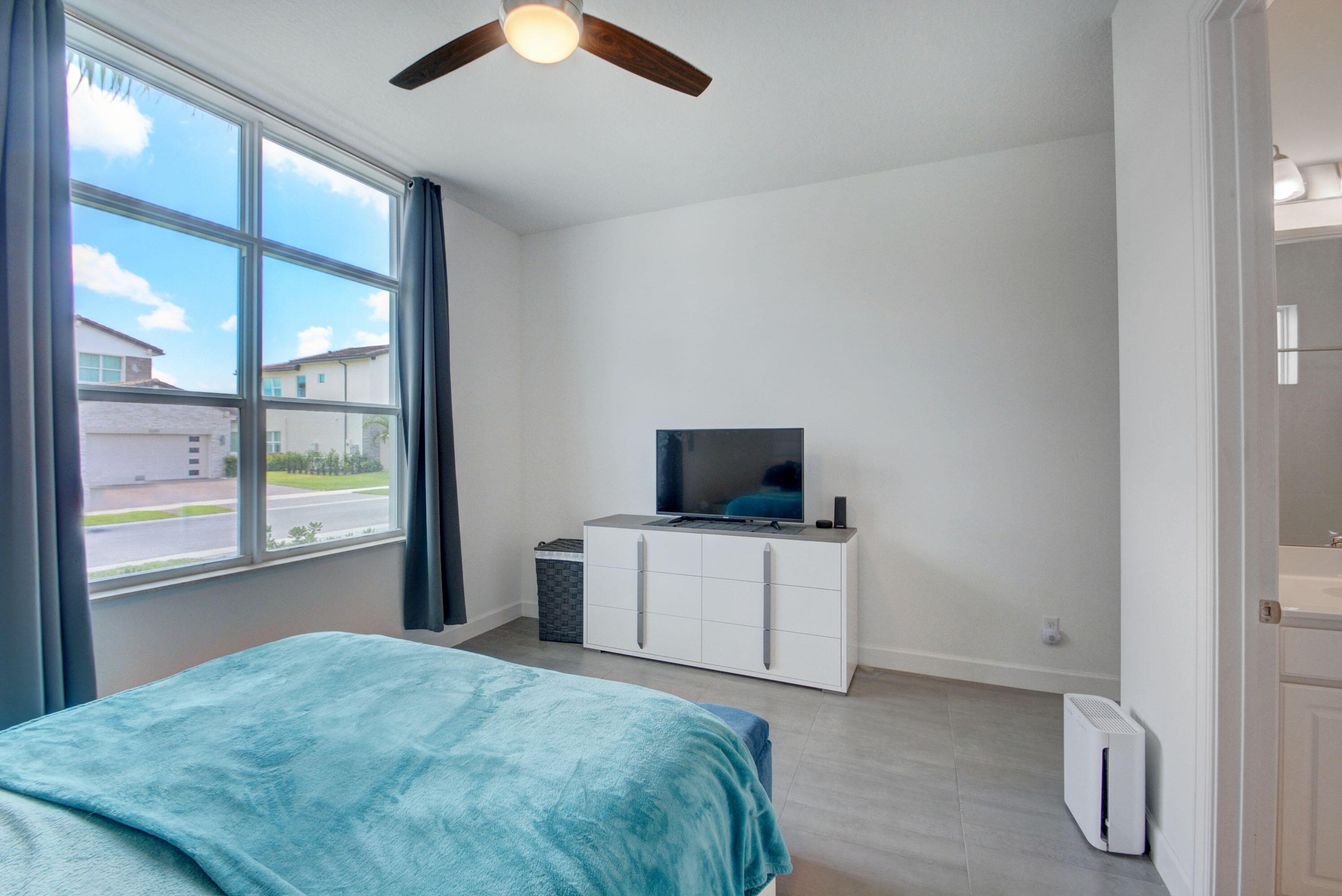 5251 Beland Drive Lake Worth, FL 33467 - Photo 43 of 56 a bedroom with a bed and a flat tv screen on dresser