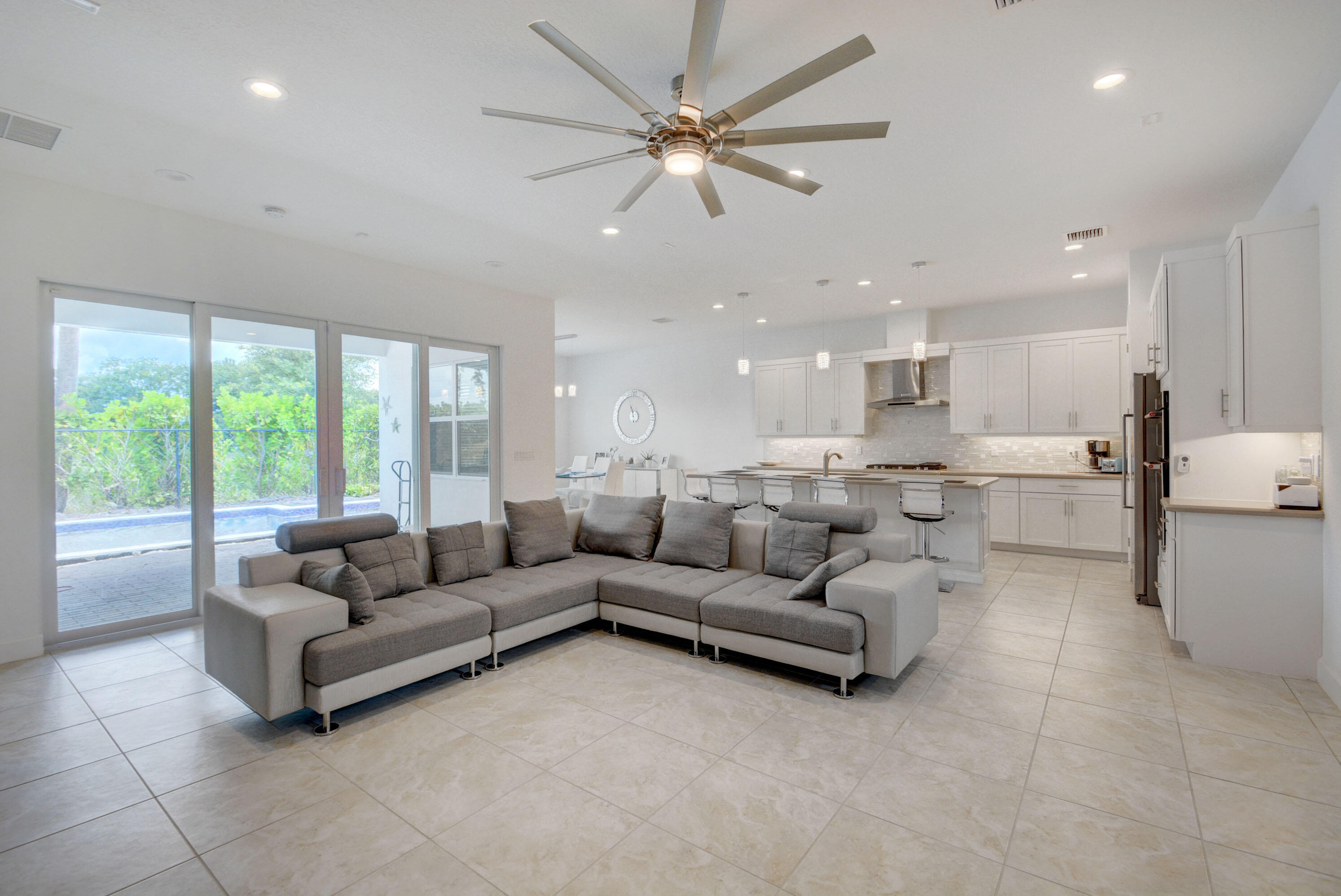 5251 Beland Drive Lake Worth, FL 33467 - Photo 9 of 56 a living room with furniture and a large window with kitchen view