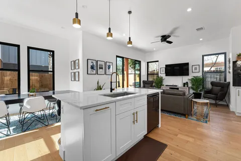 a kitchen with stainless steel appliances a sink counter space and a refrigerator