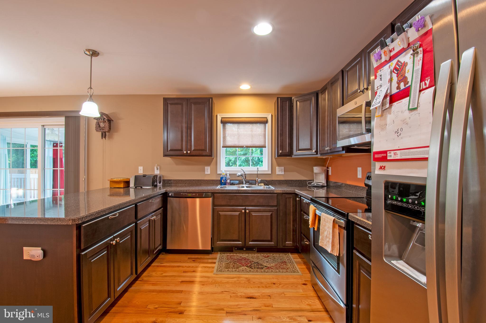 54 Minner Street Houston, DE 19954 - Photo 18 of 55 a kitchen with stainless steel appliances granite countertop a sink and a refrigerator