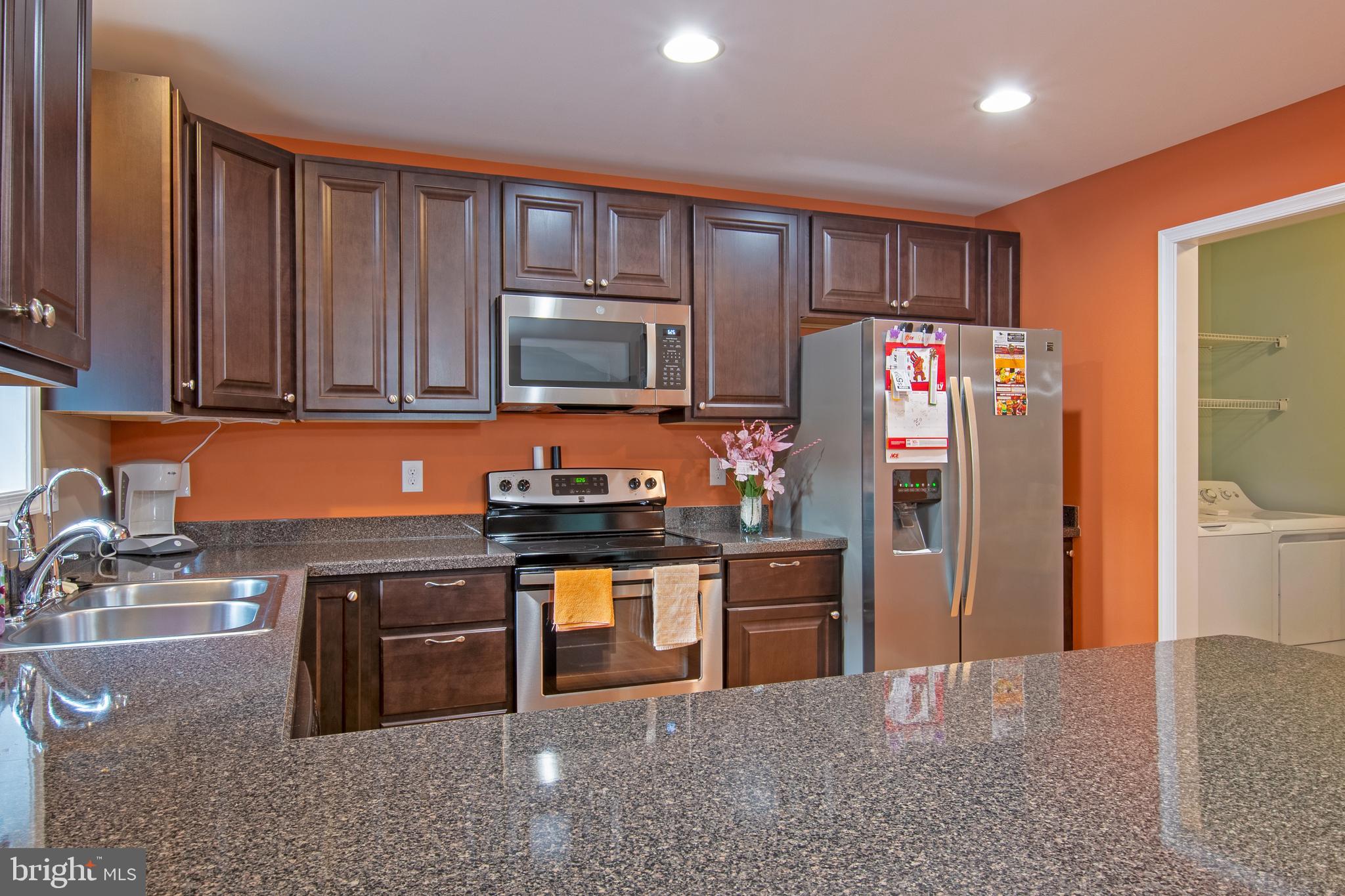 54 Minner Street Houston, DE 19954 - Photo 20 of 55 a kitchen with stainless steel appliances granite countertop a stove refrigerator and microwave