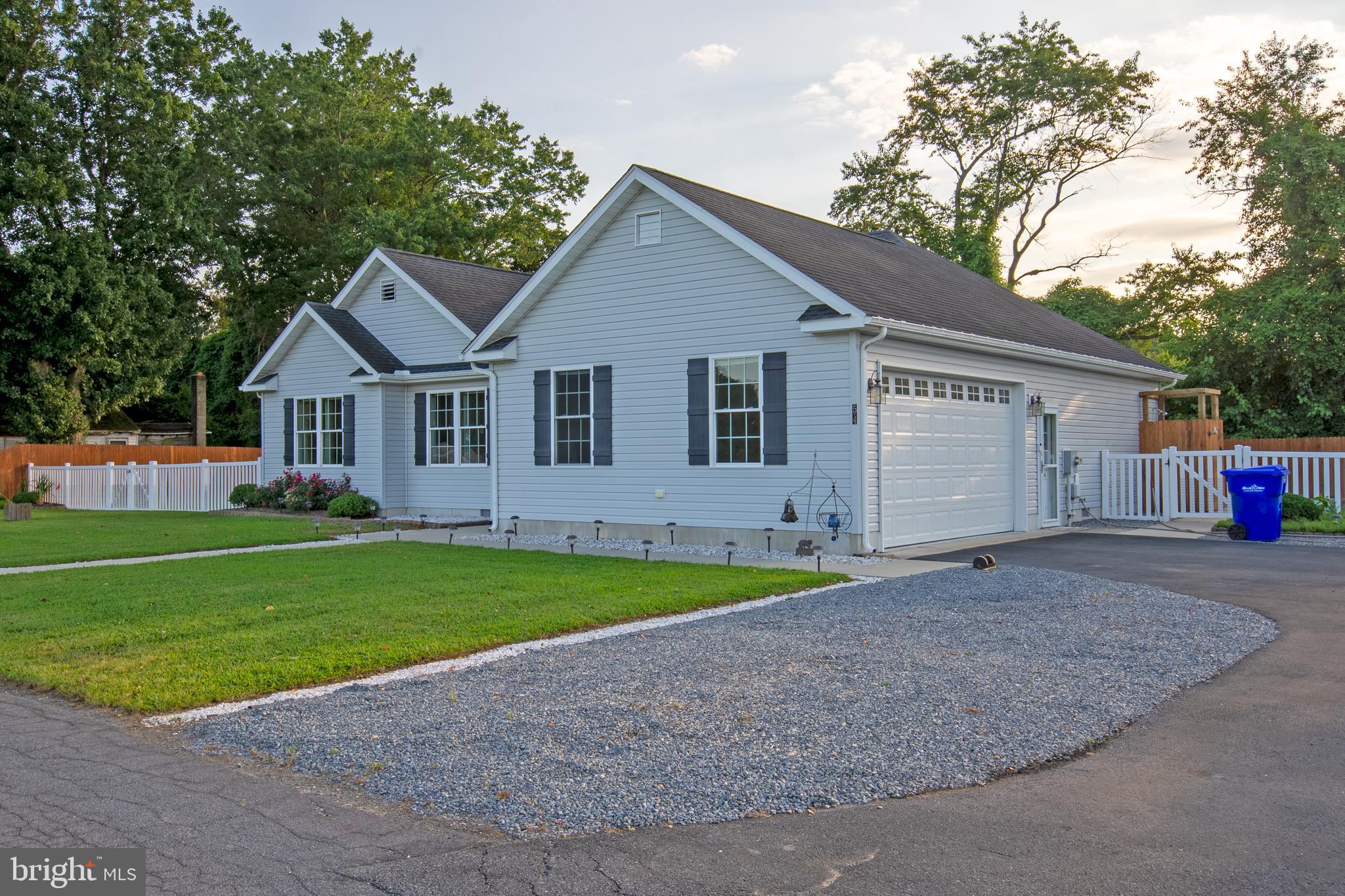 54 Minner Street Houston, DE 19954 - Photo 2 of 55 a front view of a house with a yard and garage