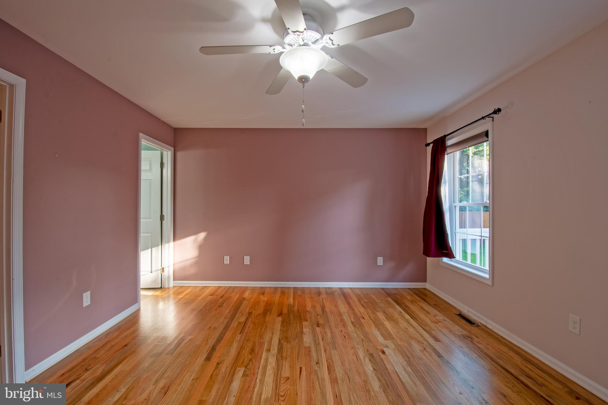 54 Minner Street Houston, DE 19954 - Photo 28 of 55 a view of an empty room with window and wooden floor