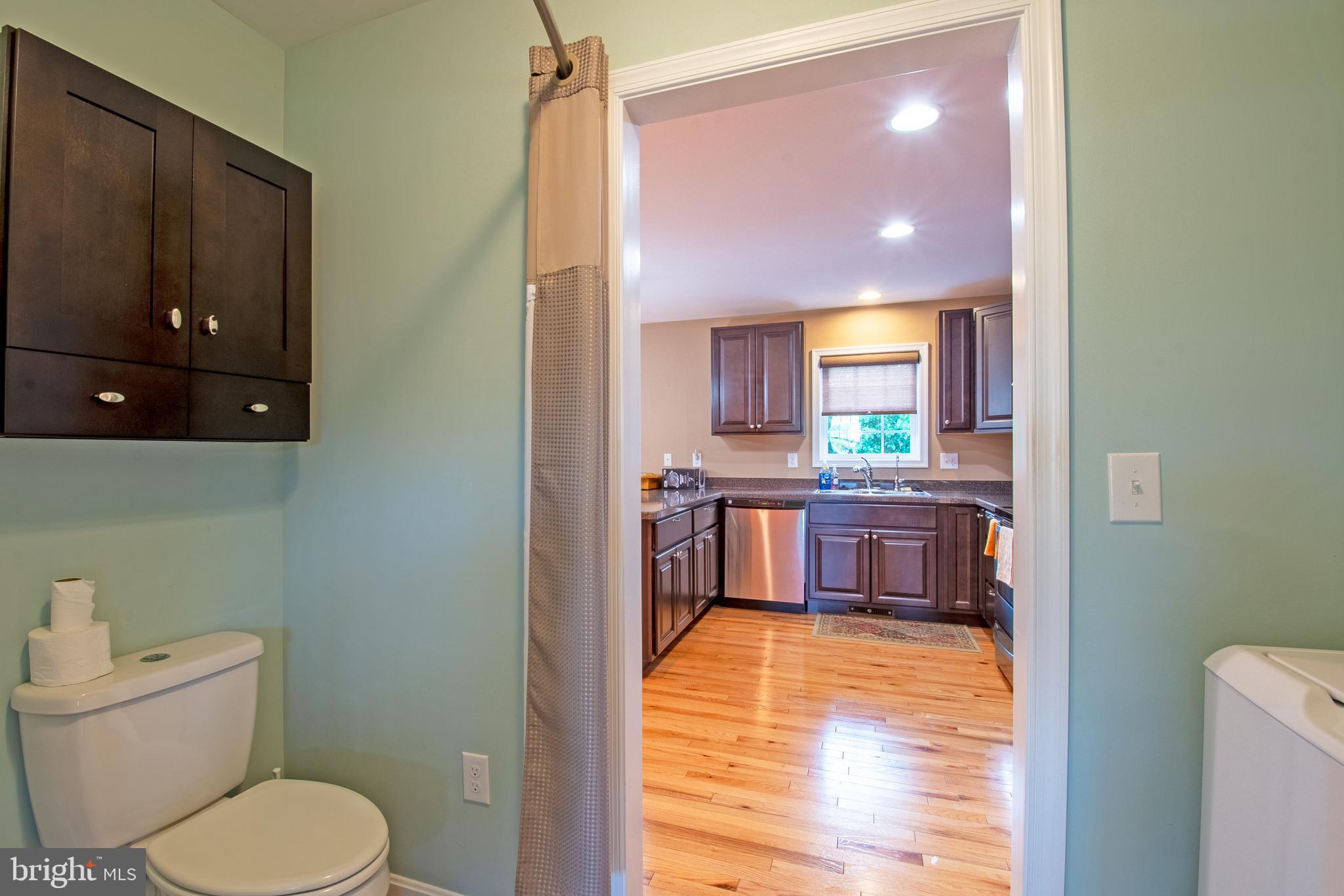 54 Minner Street Houston, DE 19954 - Photo 40 of 55 a bathroom with a toilet a sink and a mirror