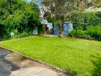 a view of a house with backyard and sitting area