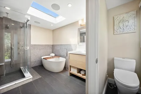 a bathroom with a toilet sink and mirror