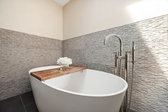 a white tub sitting in a bathroom