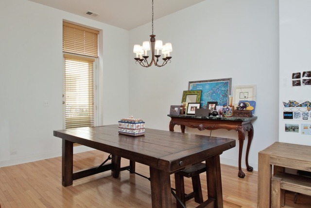 155 Whistler Road Highland Park, IL 60035 - Photo 5 of 13 a view of a dining room with furniture a chandelier and wooden floor