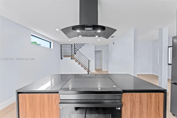 a kitchen with granite countertop a stove a sink and a cabinets