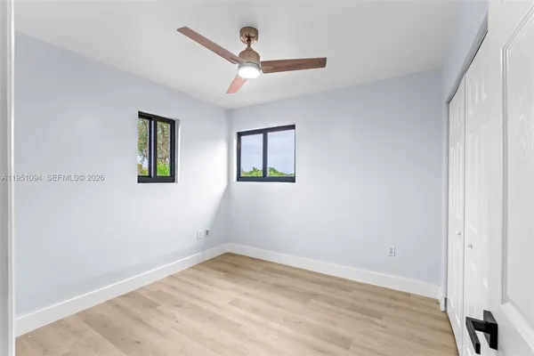a bathroom with a granite countertop sink a toilet and a mirror