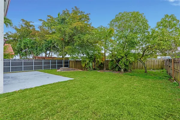 a aerial view of a house next to a yard and lake view