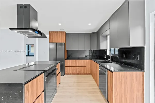 a kitchen with stainless steel appliances granite countertop a sink stove and refrigerator