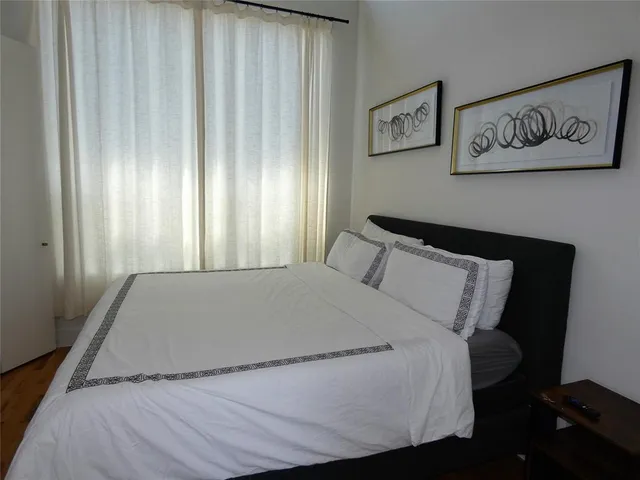 a bed sitting in a bedroom next to a window