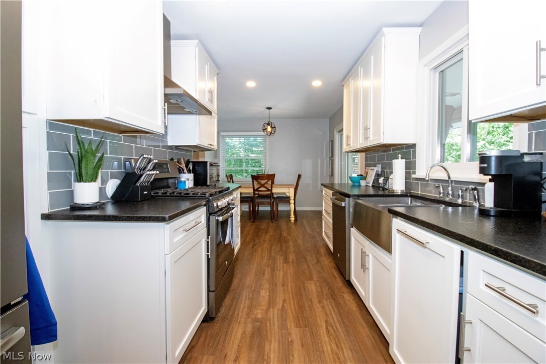 427 Oakley Road Wooster, OH 44691 - Photo 20 of 38 Kitchen featuring white cabinets, tasteful backsplash, plenty of natural light, and stainless steel appliances