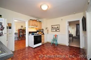 a view of a kitchen with refrigerator and a stove