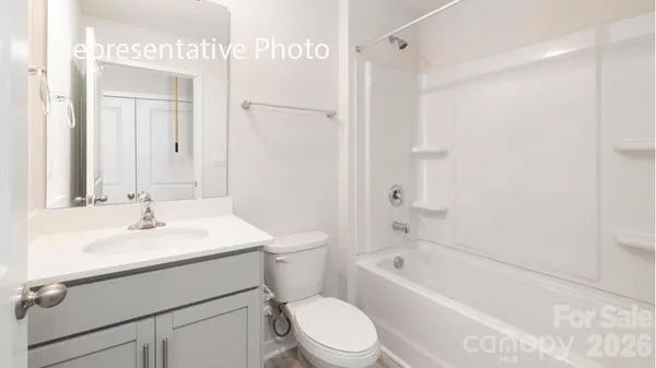 a bathroom with a sink toilet vanity and shower