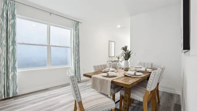 a dining room with furniture and wooden floor