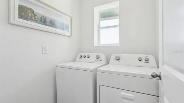 a view of storage and utility room with washer and dryer
