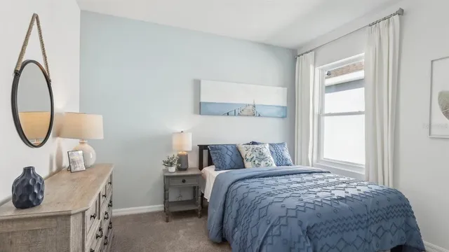 a bedroom with a bed a mirror and a window