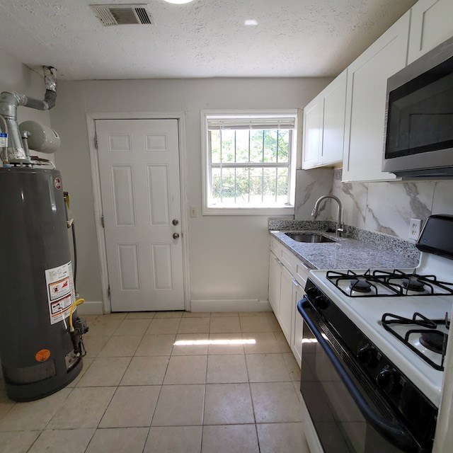 2406 Dawson Street, Unit 2 Columbus, GA 31903 - Photo 5 of 10 a kitchen with granite countertop a stove and a sink