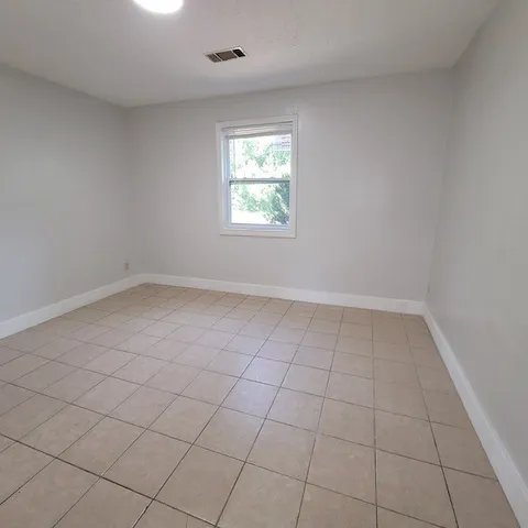 an empty room with white walls and window
