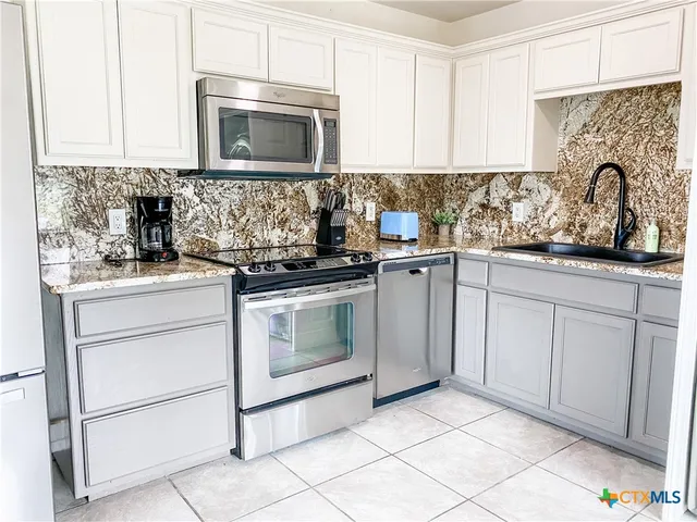 a view of a porch with wooden floor and furniture