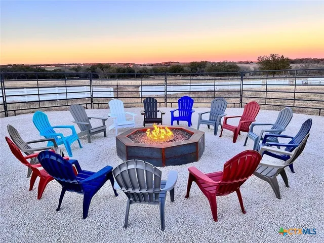 a living room with fireplace furniture and a rug