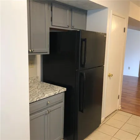 a kitchen with metallic refrigerator freezer and a dishwasher