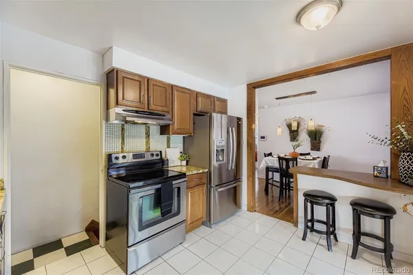 a kitchen with stainless steel appliances a stove a refrigerator and a refrigerator